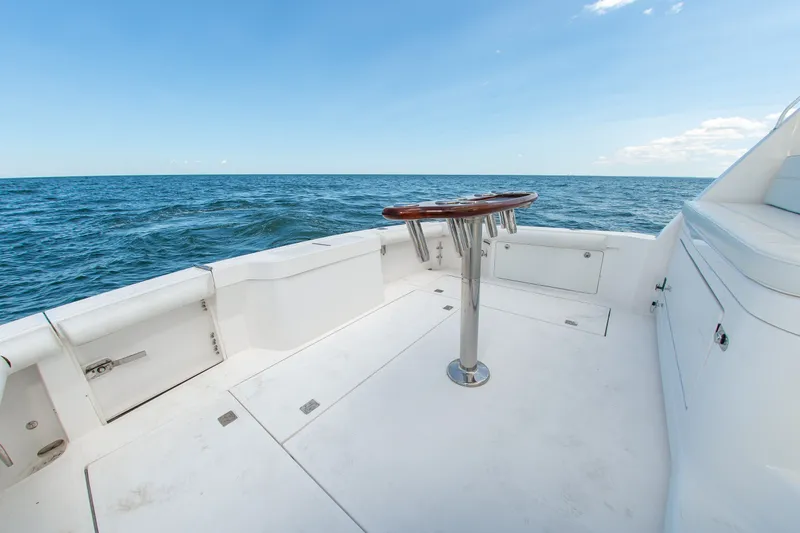 Slide: The Image of 2013 Cabo 40 Hardtop Express boat deck with ocean view and clear sky. - 22
