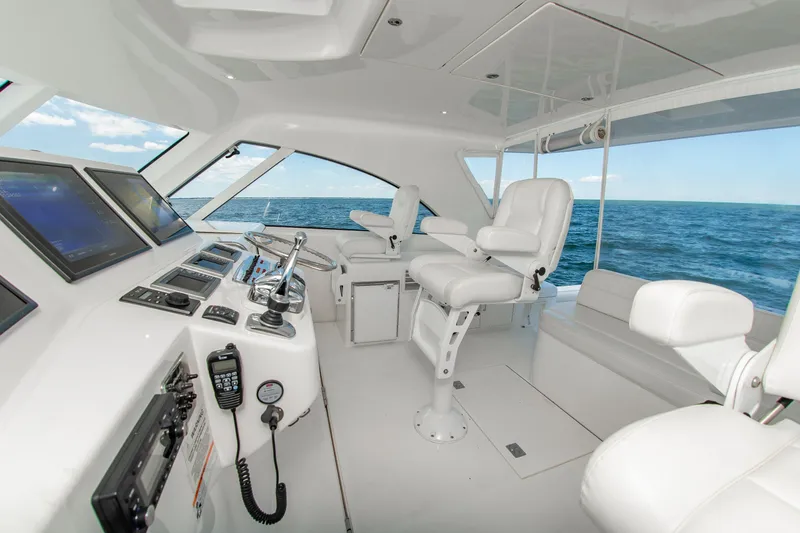Slide: The Image of Interior of 2013 Cabo 40 Hardtop Express yacht with modern navigation equipment and ocean view. - 15