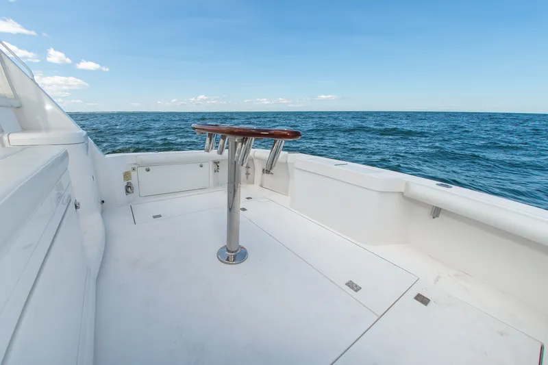 Slide: The Image of 2013 Cabo 40 Hardtop Express boat deck with ocean view and clear blue sky. - 21