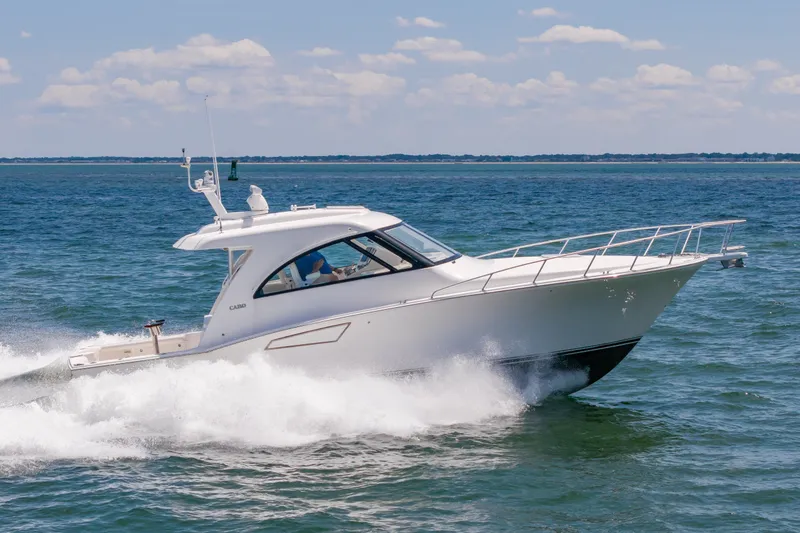 Slide: The Image of 2013 Cabo 40 Hardtop Express cruising on open water under clear skies. - 24
