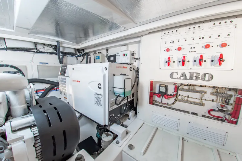 Slide: The Image of Engine room of 2013 Cabo 40 Hardtop Express with Cummins Onan generator and control panel. - 36