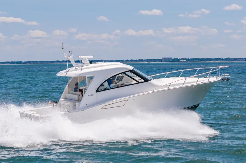 Slide: The Image of 2013 Cabo 40 Hardtop Express cruising on open water under a clear sky. - 25