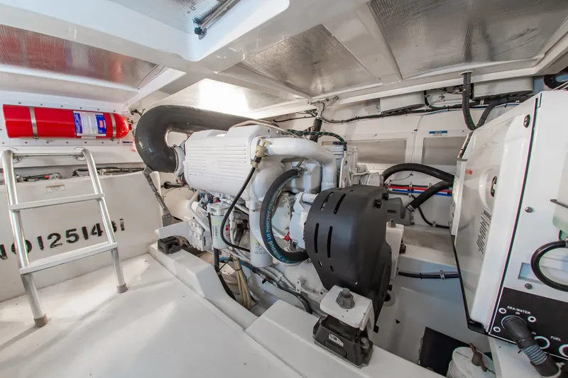 Slide: The Image of Engine room of 2013 Cabo 40 Hardtop Express with visible machinery and fire extinguisher. - 37