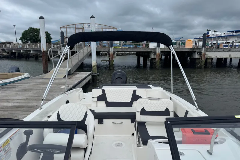 Slide: The Image of 2024 Bayliner VR6 Bowrider OB docked, featuring spacious seating and sleek design. - 4