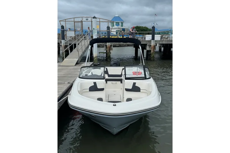 Slide: The Image of 2024 Bayliner VR6 Bowrider OB docked at marina, featuring sleek design and spacious seating. - 3