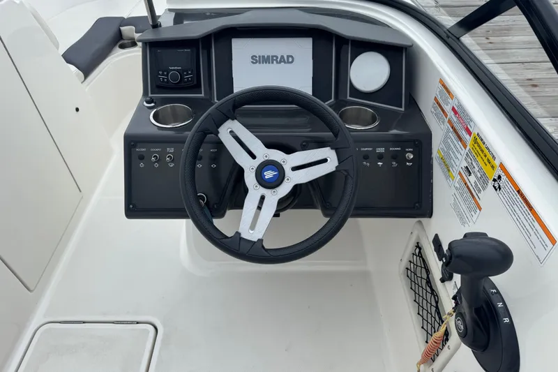 Slide: The Image of 2024 Bayliner VR6 Bowrider OB dashboard with steering wheel and control panel. - 5