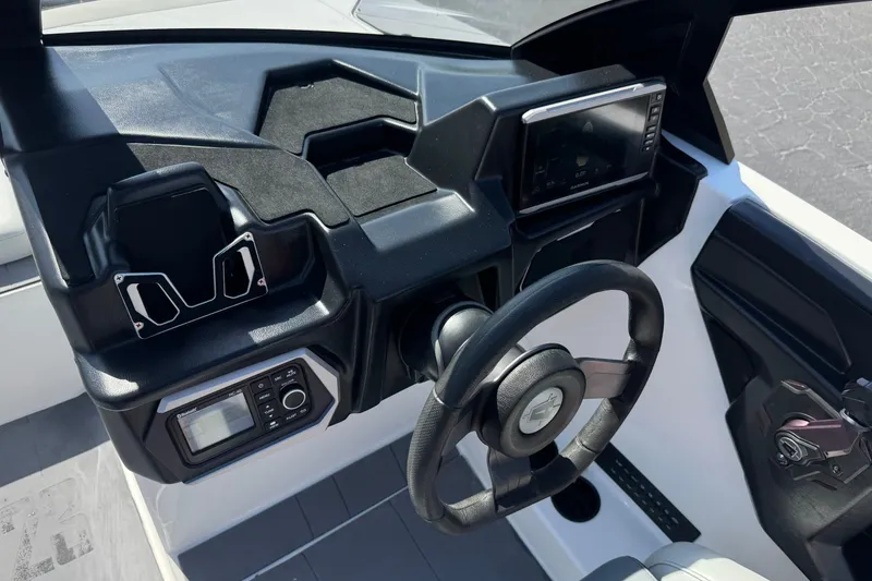 Slide: The Image of 2022 Axis T23 boat dashboard with steering wheel and control panel. - 29