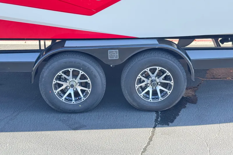 Slide: The Image of 2022 Axis T23 trailer wheels with black fenders on asphalt surface. - 34