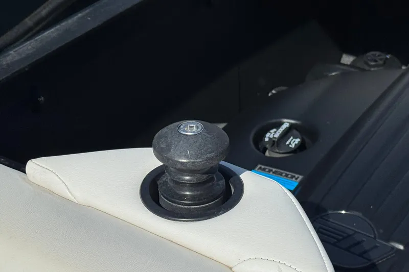 Slide: The Image of 2022 Axis T23 boat interior detail with engine and control knob. - 22