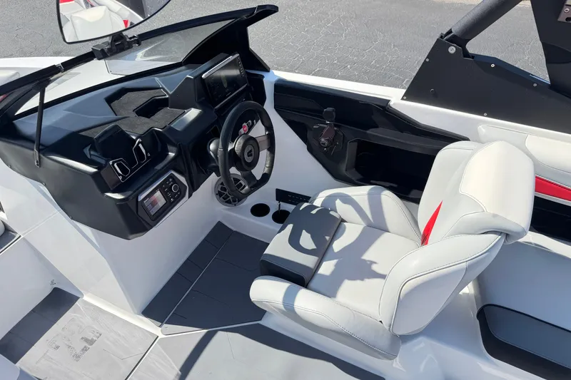 Slide: The Image of 2022 Axis T23 boat interior with modern dashboard and comfortable seating. - 27