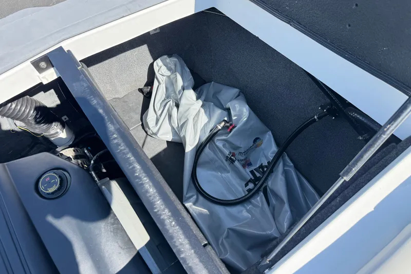 Slide: The Image of 2022 Axis T23 boat storage compartment with ballast bag and hoses. - 20