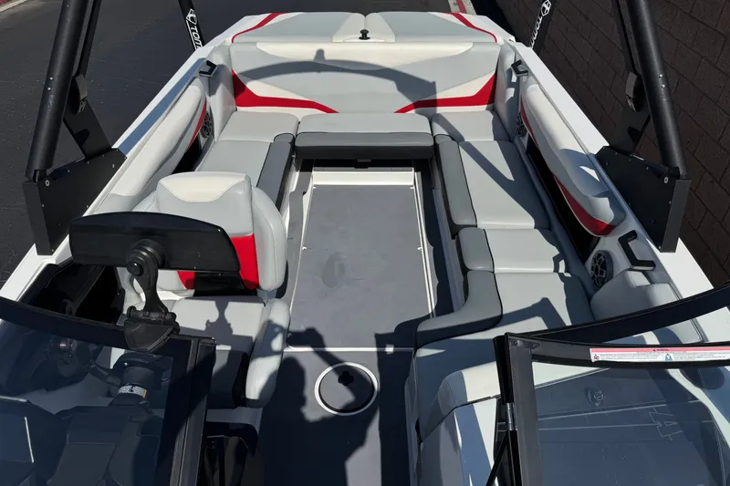 Slide: The Image of 2022 Axis T23 boat interior with gray and red seating, open layout. - 15