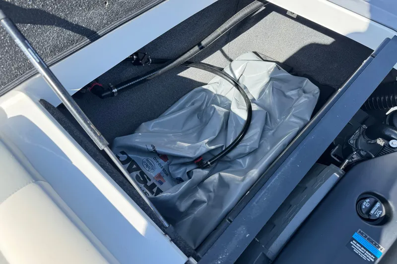 Slide: The Image of 2022 Axis T23 boat storage compartment with ballast bag and hoses. - 19