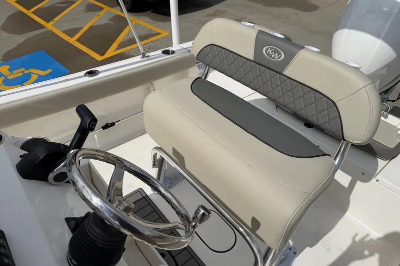 Slide: The Image of Interior of 2026 Key West 189 FS boat featuring steering wheel and cushioned seating. - 15