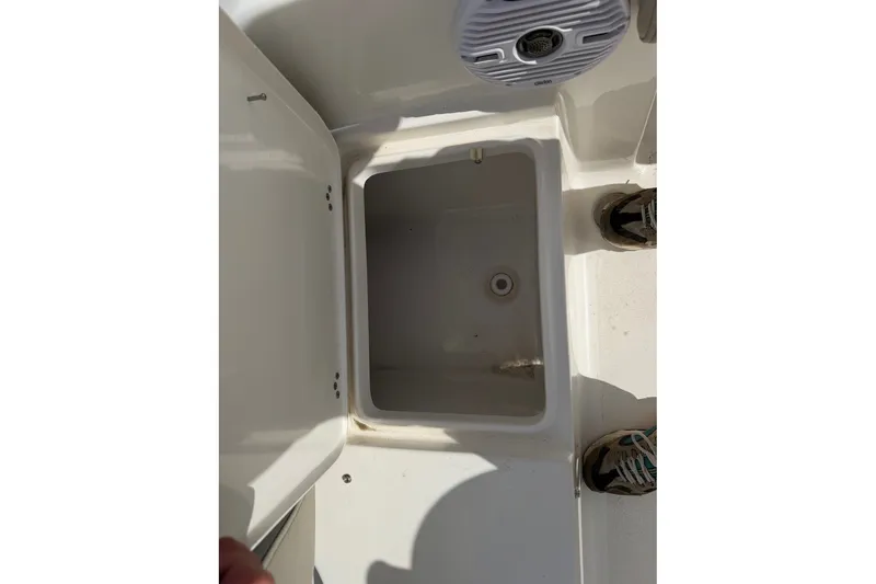 Slide: The Image of Open storage compartment on 2026 Key West 189 FS boat deck. - 9