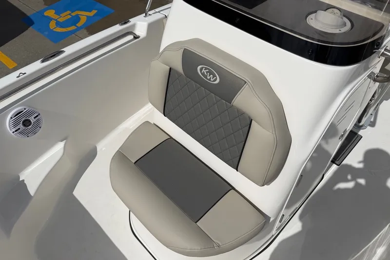 Slide: The Image of 2026 Key West 189 FS boat seat with KW logo, featuring gray and beige upholstery. - 19