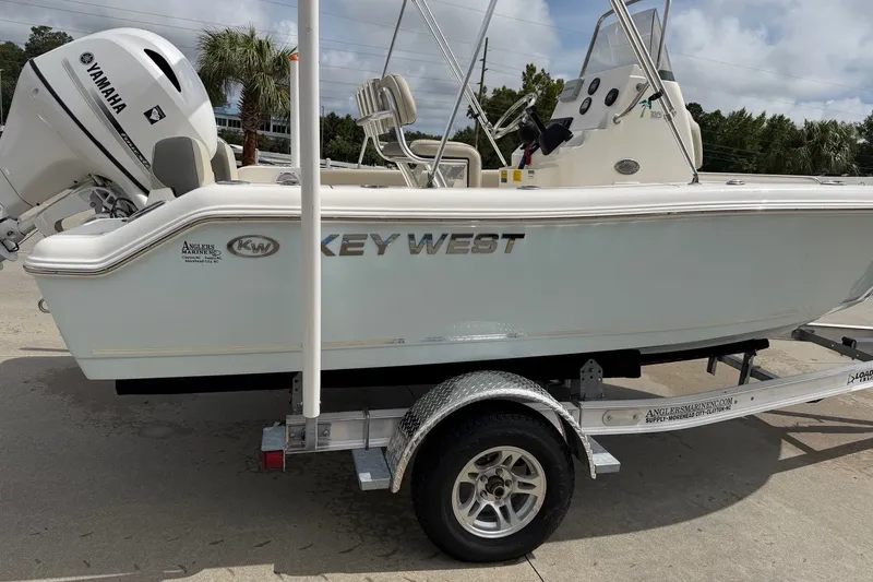 Slide: The Image of 2026 Key West 189 FS boat on trailer with Yamaha engine, parked outdoors. - 6