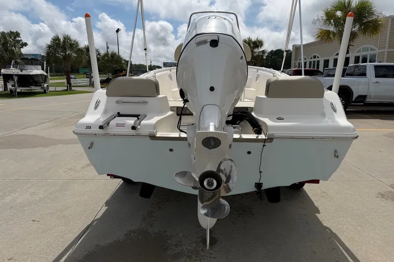 Slide: The Image of 2026 Key West 189 FS boat rear view with outboard motor in a sunny marina. - 4