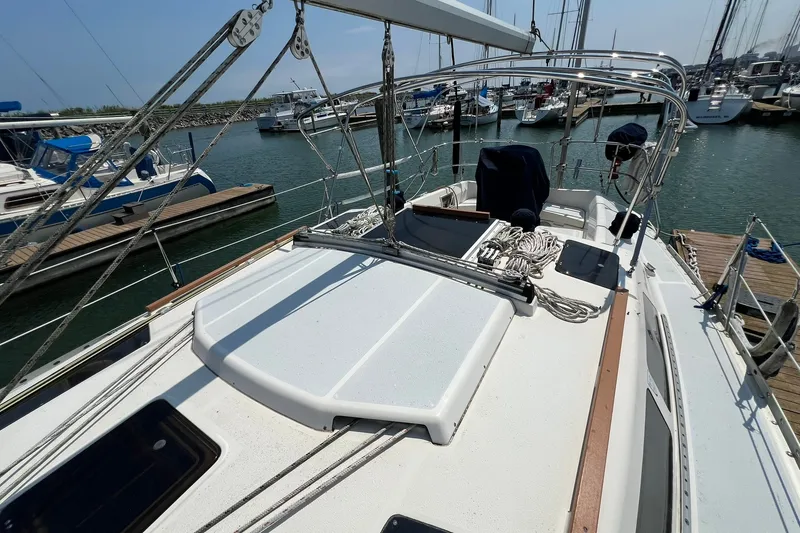 Slide: The Image of 1990 Hunter Legend 35.5 sailboat docked at marina, showcasing deck and rigging. - 3