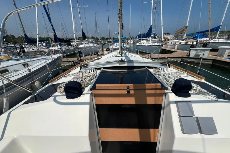 Slide: The Image of Hunter Legend 35.5 sailboat from 1990 docked at a marina, surrounded by other boats. - 5
