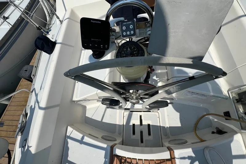 Slide: The Image of Cockpit view of 1990 Hunter Legend 35.5 sailboat with steering wheel and navigation instruments. - 11