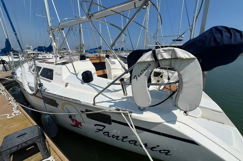 Slide: The Image of 1990 Hunter Legend 35.5 sailboat named Fantasia docked at a marina. - 1