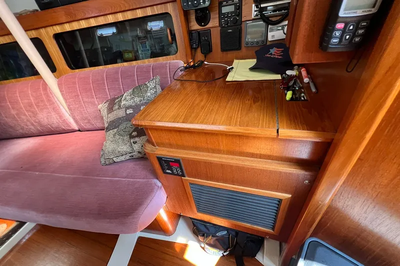 Slide: The Image of Interior of 1990 Hunter Legend 35.5 sailboat with wood cabinetry and pink seating. - 23