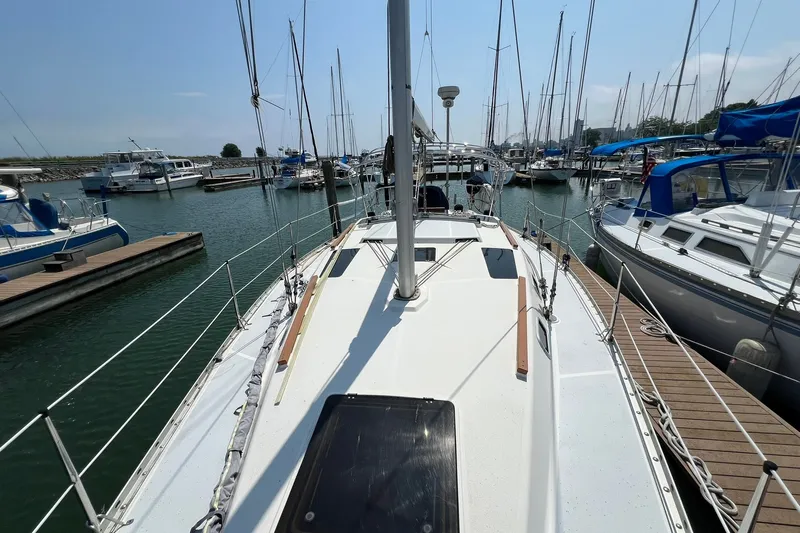 Slide: The Image of Sailboat docked in marina, 1990 Hunter Legend 35.5, surrounded by other boats. - 2