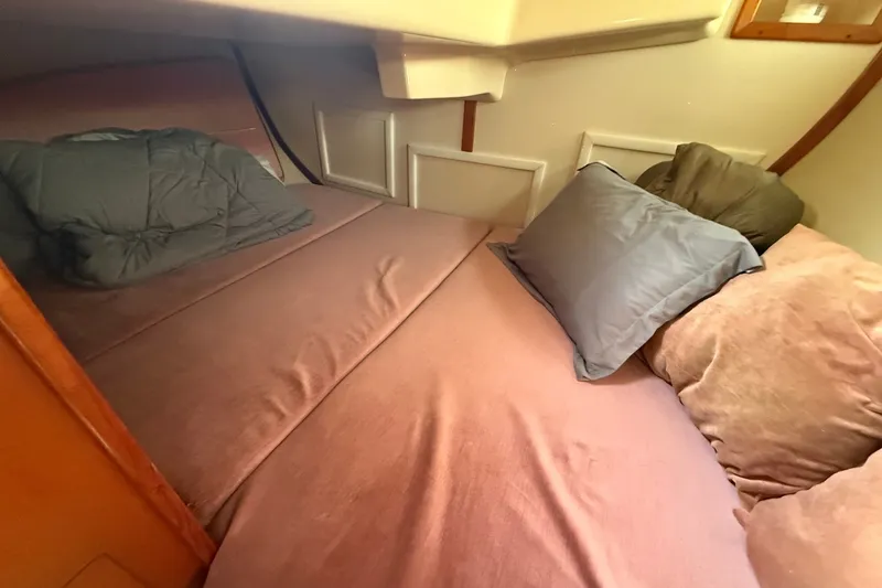 Slide: The Image of Cozy cabin bed in 1990 Hunter Legend 35.5 sailboat with pillows and soft bedding. - 35