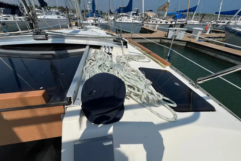 Slide: The Image of Hunter Legend 35.5 sailboat deck with ropes, docked in marina, 1990 model. - 6