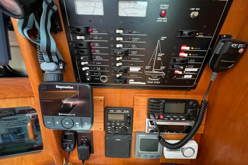 Slide: The Image of Control panel of a 1990 Hunter Legend 35.5 sailboat with navigation and communication equipment. - 27