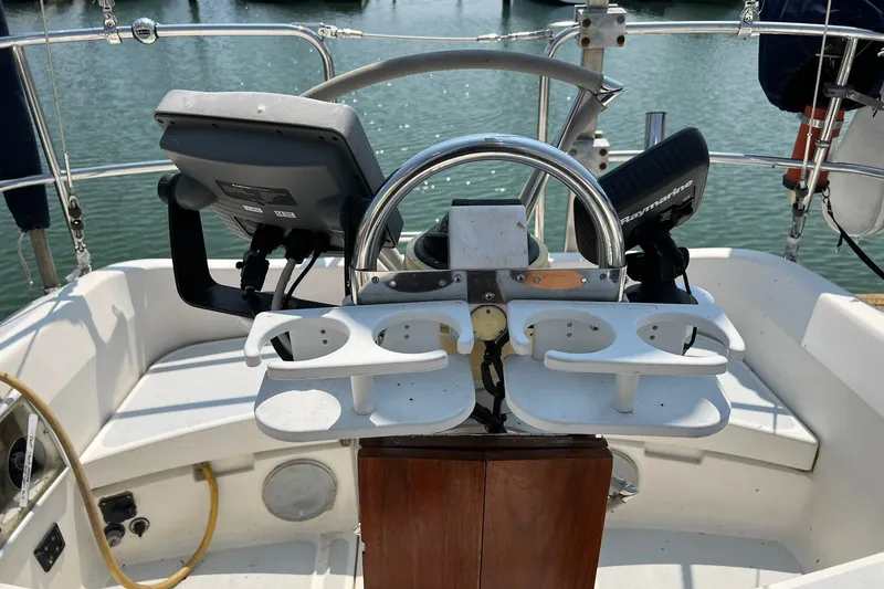 Slide: The Image of Cockpit of 1990 Hunter Legend 35.5 sailboat with steering wheel and navigation equipment. - 10