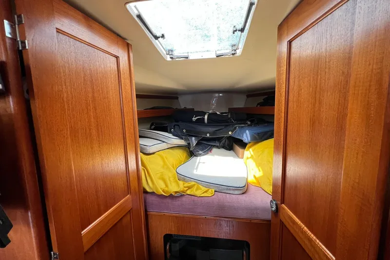 Slide: The Image of Interior cabin of 1990 Hunter Legend 35.5 sailboat with wooden doors and storage. - 33
