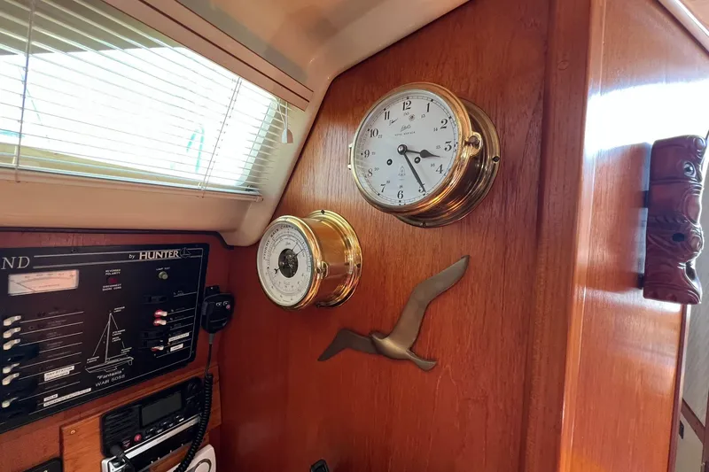 Slide: The Image of Interior of 1990 Hunter Legend 35.5 yacht with clock and barometer on wooden panel. - 26