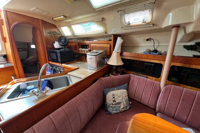 Slide: The Image of Cozy interior of 1990 Hunter Legend 35.5 sailboat with kitchen and seating area. - 24