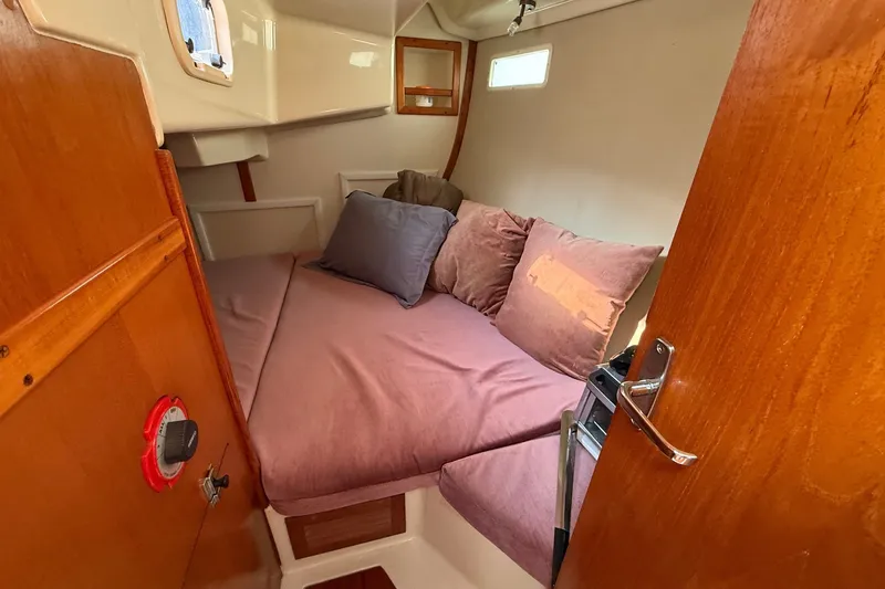 Slide: The Image of Cozy cabin interior of 1990 Hunter Legend 35.5 sailboat with plush bedding. - 34