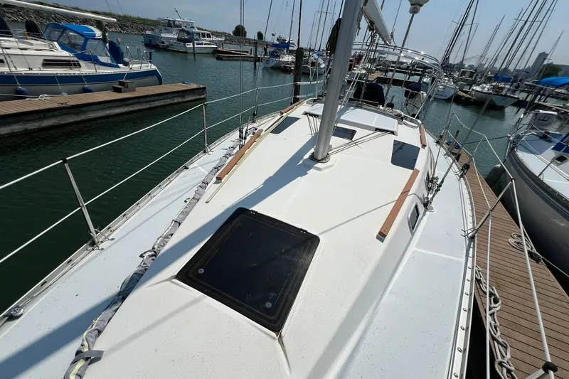 Slide: The Image of Sailboat Hunter Legend 35.5, 1990 model, docked in a marina with other boats. - 4