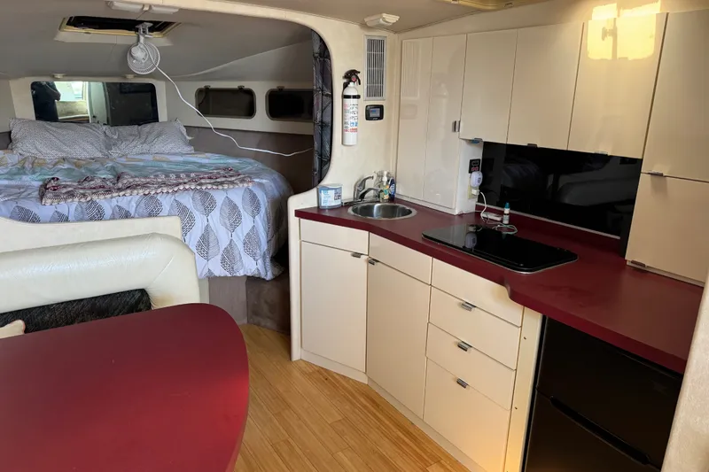 Slide: The Image of Interior of a 1990 Silverton 34 Express boat with kitchenette and cozy sleeping area. - 19