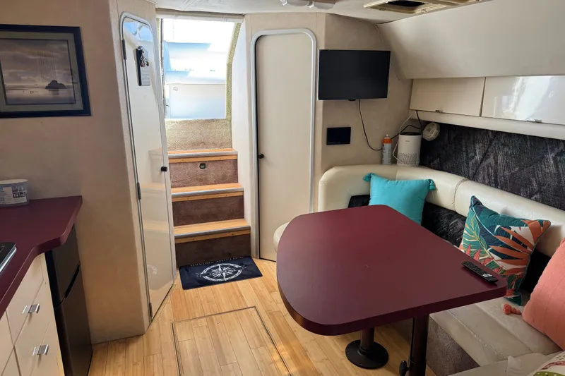Slide: The Image of Interior of a 1990 Silverton 34 Express boat with cozy seating and modern amenities. - 21