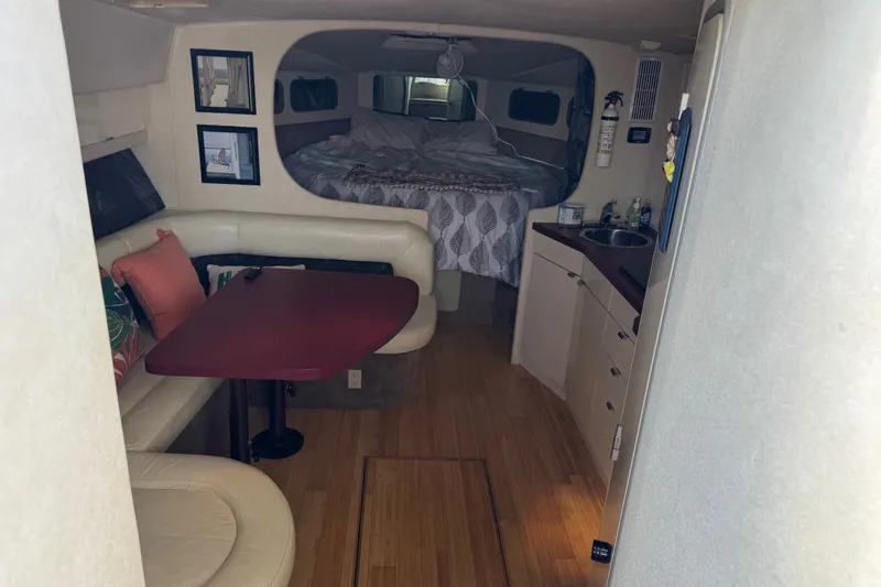 Slide: The Image of Interior of a 1990 Silverton 34 Express boat with cozy seating and sleeping area. - 18