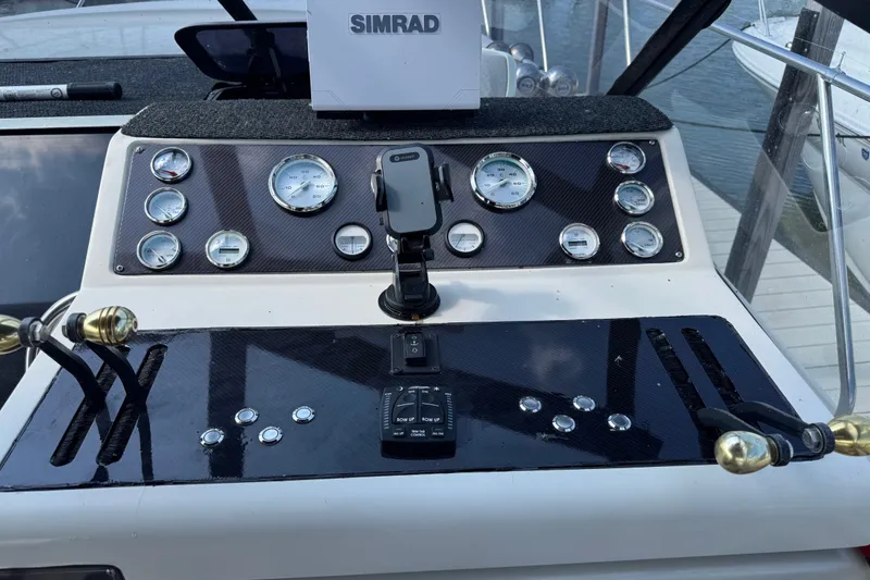 Slide: The Image of Control panel of a 1990 Silverton 34 Express boat with gauges and navigation equipment. - 14