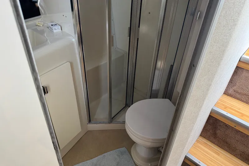 Slide: The Image of Bathroom interior of 1990 Silverton 34 Express yacht with shower and toilet. - 25