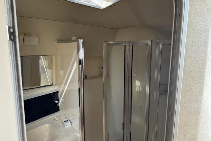 Slide: The Image of Bathroom interior of 1990 Silverton 34 Express boat, featuring shower and sink area. - 26
