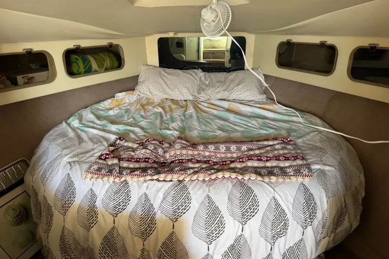Slide: The Image of Cozy cabin interior of 1990 Silverton 34 Express with bed and decorative bedding. - 22
