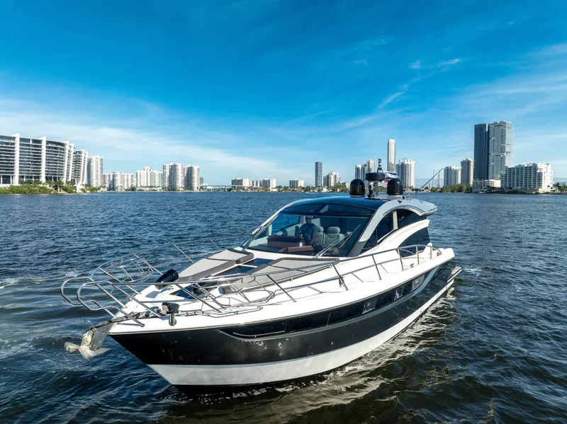 Slide: The Image of 2016 Galeon 430 HTC yacht cruising near city skyline on a sunny day. - 3