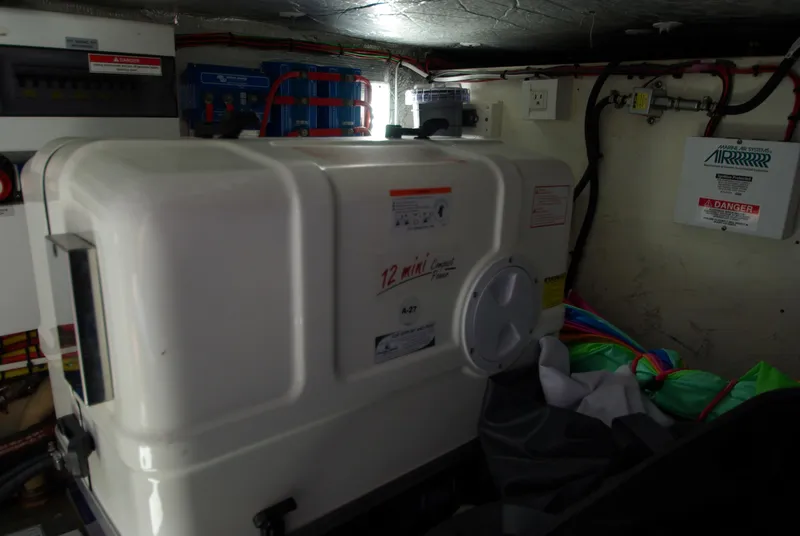 Slide: The Image of The engine room of a 2016 Galeon 430 HTC features a large generator and electrical connections. - 61