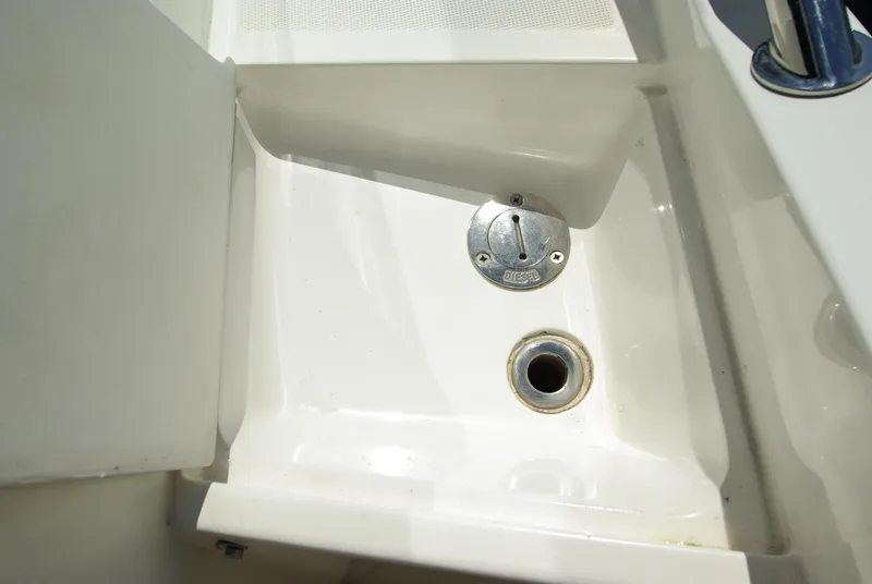 Slide: The Image of Close-up of a white boat deck with a drain and metal cover. - 52