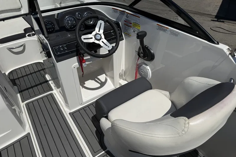Slide: The Image of 2023 Bayliner VR4 Bowrider I/O cockpit with steering wheel and seating. - 15