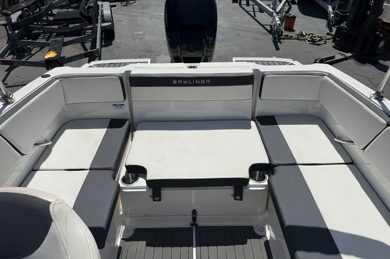 Slide: The Image of 2023 Bayliner VR4 Bowrider I/O interior with cushioned seating and cup holders. - 6