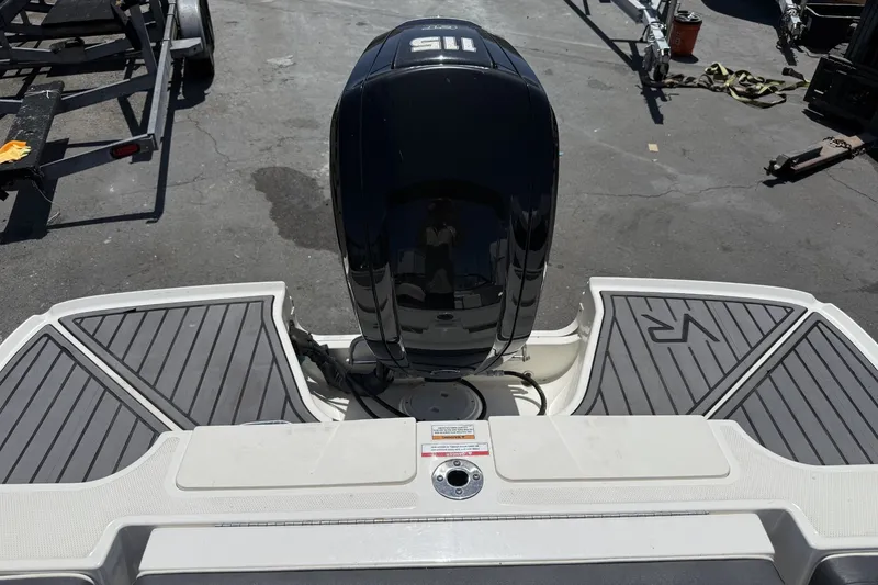Slide: The Image of 2023 Bayliner VR4 Bowrider I/O boat with sleek deck and powerful engine. - 10